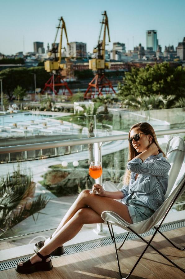 Sls Buenos Aires Puerto Madero Hotel Exterior photo A woman drinking an Aperol Spritz
